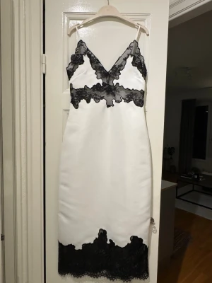 Lace dress from H&M in S size  - Never used white dress from H&M in S size. It has lace detail at the bottom and top.  Fabric is like satin soft but thick and stiff. It has adjustable straps. Dress is well tailored. Length comes above the ankle to me (165cm tall).  Please ignore the wrinkles, it was kept folded in wardrobe.  Perfect dress for dates, wedding or special day!  