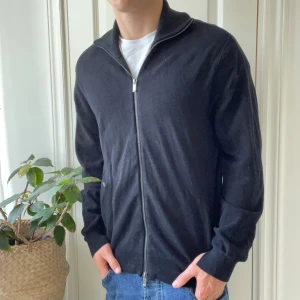Full zip Massimo Dutti svart M - Full zip Massimo Dutti svart M, det har liksom gått upp i ärmen. Känns väldigt naturligt. Modellen är 180,75 kg. 