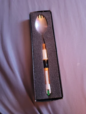 Doctor Who sonic spork  - Official BBC Doctor Who sonic spork based off the 11th doctor's sonic screwdriver. You can put it in a pocket spork side down to add a sonic screwdriver to your outfit or cosplay.  The box has sustained some damage, however the spork is not affected.