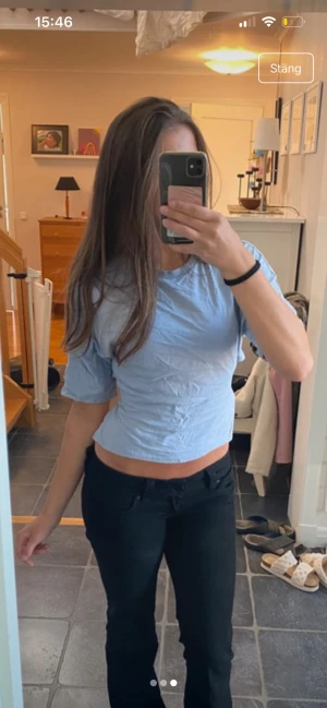 Ljusblå croppad topp med knyt i ryggen - Säljer en ljusblå croppad topp med korta ärmar och snygg öppen rygg med knytband. Toppen har en enkel och fräsch look, perfekt till jeans eller kjol. Materialet känns som bomull och toppen har en lätt loose passform.