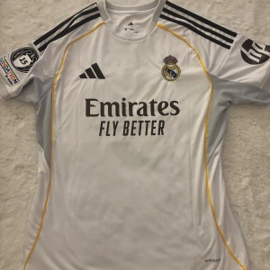 Real Madrid Mbappé Merchandise  - Selling a Real Madrid t-shirt i bought in turkey and it’s brand new it just didn’t fit me. It says size M on the label but it almost reaches my knees and i’m around 150 cm tall. I only used it once and that was the time i tried it lol