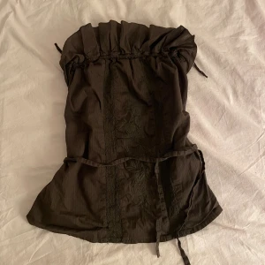 Brun topp - Brun vintage ärmlös topp som går att knyta både framtill och bak, fina detaljer. Strl M