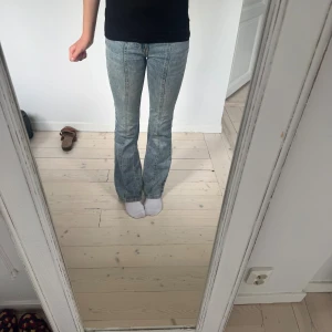 Blå bootcut jeans med ljus tvätt - Snygga blå jeans med bootcut-modell och ljus tvätt. Klassisk femficksdesign och normal passform. Högmidjade.