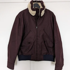 ACNE Jacket - Fits like size M/48(male). The elastic in the waist line is navy blue (not very clear in the image). Attention, the jacket was bought on internal sales, hence the marker on the tag.