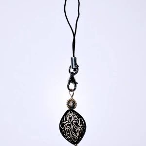 Svart accessoar till tex mobil/kläder - Svart akrylpärla med guldspringor, guldig metallpärla med glittrigt bling.