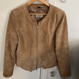 Beige Mocka-jacka  - Köpt secondhand för 500kr, inga defekter eller fläckar  Dubbelsidig dragskedja Stl L men sitter perfekt på mig som brukar ha S