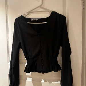 Blus / topp - Jätte fin topp i svart, med lite ribb vid midjan samt armarna. Storlek s. Använd få tal gånger, i bra skick! 