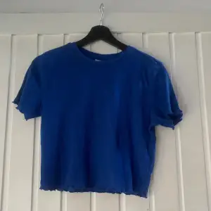 En helt vanlig mörkblå t-shirt. Rätt så kort men inte jätte. Väldigt skön i materialet, säljer för den inte kommer till användning 😁