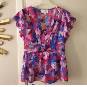 blus - Superfin topp med lite volang & lite resår bak. Aldrig använts så i nyskick.