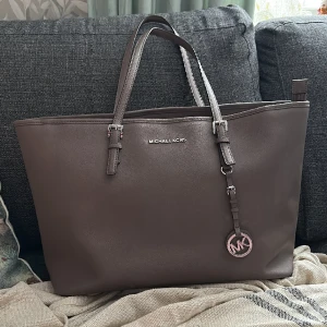 Michael kors jet set - Med silverdetaljer, jätte fint skick! Säljes utan dustbag.  Köpt nyligen på tradera. 