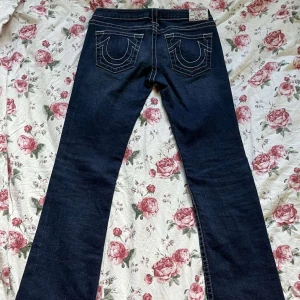 True religion jeans - Snyggaste marinblåa lågmidjade bootcut true religion jeansen med vita sömmar! Knappt änvända och i bra skick👍  pris går att diskutera💞 Storleken står inte men dom sitter som S. innerbenslängden-85cm midjan-40cm totala längden-106cm  