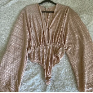 NLY TREND BLUS XS - Säljer denna snygga plisserade body inköpt från NLY TREND. Använt den en gång på ett event och är i fint skick! 