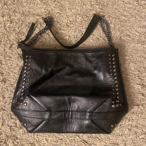 Väska  - Säljer en super fin och trändig väska då jag köpt mig en ny💘 väskan har två små 3 små fickor inuti, väskan i säg är super tycker jag inte bara med nitarna på väskan utan även kedje bandet!❤️❤️