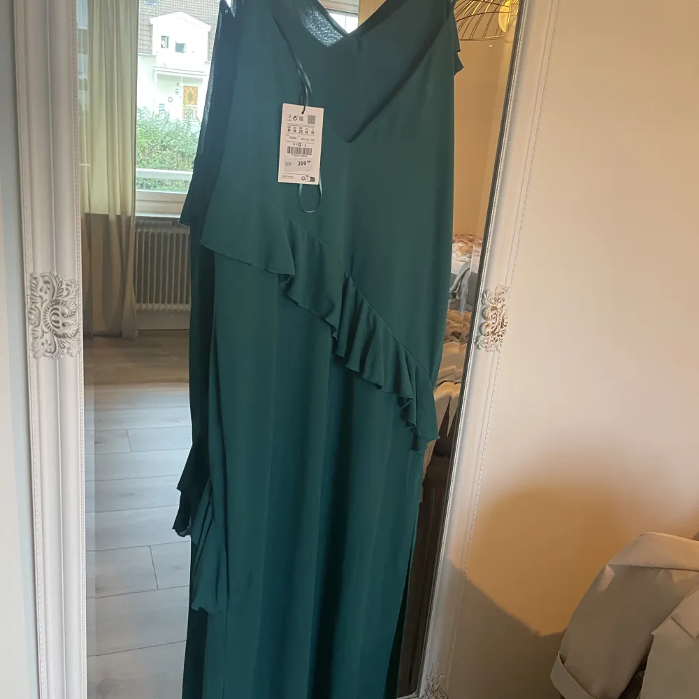 Grönblå långklänning från Bershka. Skiftar i nyans beroende på ljus. Prislappen sitter kvar då jag inte haft tillfälle att använda klänningen.  Nypris 399 mitt pris 200. Klänningar.