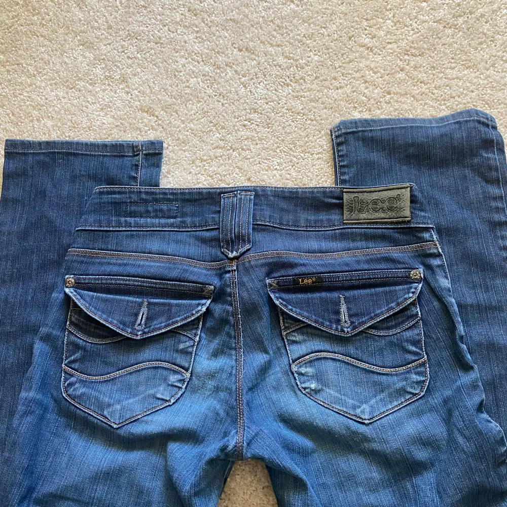 Lågmidjade Lee jeans i en mörk tvätt med coola fickor där bak, för små för mig tyvärr. Jeans & Byxor.