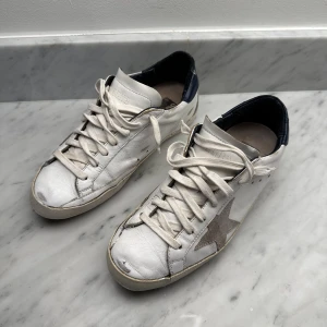 Golden Goose superstar - Välanvända och reparerade Golden Goose skor i storlek 40. Det har gjorts en touch up färgen och sulan har blivit fixad med ny gummi. Skulle man sula om hos GG så går det på 2000. Skorna är från 2017 och snörena är vita istället för gråa, mycket snyggare! 