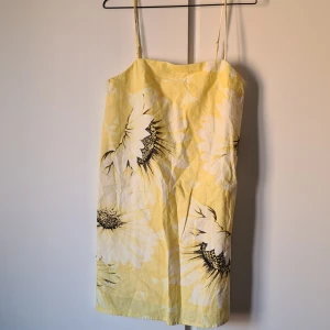 Oanvänd gul klänning med solrosor - Kort alinje-formad modell
