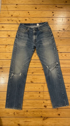 Vintage 1990 Levis 505 - Äldre Levis 501 med snygg slitning och hål på båda knän. Sitter som typ 33/34 trots storlek