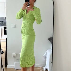 Set - Grönt set i med kjol och skjorta i siden-liknande material. I storlek S och 36. Setet säljs tillsammans.