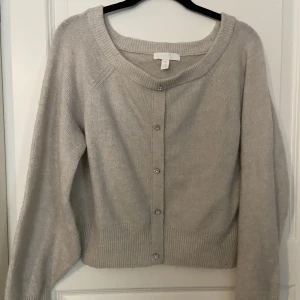 Stickad med blommor - Hel och ren tröja, använd ett par gånger men inget man märker utom att den blir lite knottrig. 52% polyester