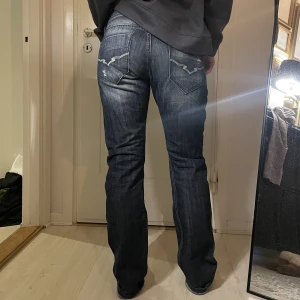 Jeans - Klassisk denimblå jeans från Rookies Jeans. 100% Cotton. Bring back 00’s! Modell för honom (strl M, 180 cm) men passar även henne (strl S, 170 cm). 
