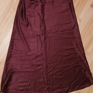Lång kjol i Siden - A-linje formad längre kjol i silkigt/siden tyg. Vinröd. Resår i midjan. M/S