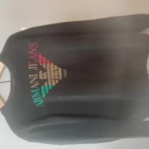 Sweatshirt av märket Emporio Armani i reaggaefärger. Storlek L. Jättefint skick