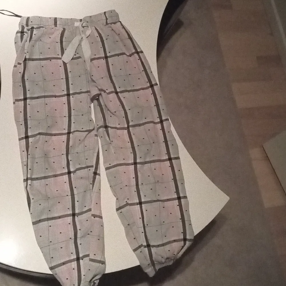 Pjamas byxor i st 146/152 det har små hjärtan och har färg svart grå och rosa. Jeans & Byxor.