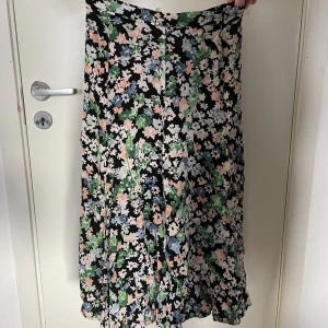 Blommig kjol - Jättesöt blommig längre kjol 🌸 Jättefin till sommaren. Den har en dragkedja vid sidan och går till ankeln på mig som är 156cm. Säljer då den tyvärr är lite liten. Nypris 249kr säljer för 90kr💕