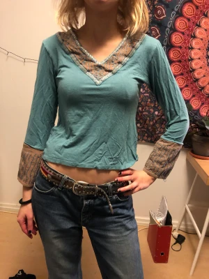Tröja med utsvängda ärmar - Superfin turkos färg med bruna detaljer. Luftigt och svalt material. 