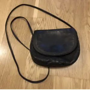 En så fin handväska med magnetspänne och två stycken fack inuti. 