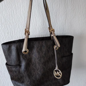 Michael Kors väska  -  Varan har tecken på användning men varit väl omhändertagen.