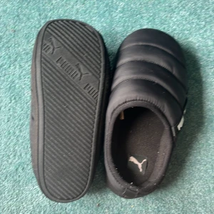 Puma tofflor  - Sköna puma tofflor. De har en liten repa på framsidan av ena tofflan men märks knappt. De är storlek 40,5 men passar även 41,5