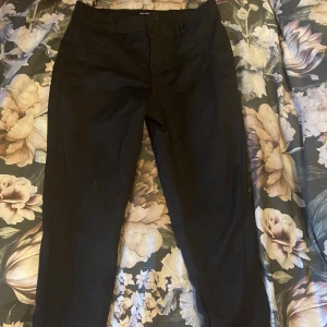 Vero moda kostymbyxor stl m30 - I nyskick, enbart använda nån gång. Rejäla kostymbyxor i lite kraftigare tyg. Knäpps med knapp och ögla. Nypris 450.