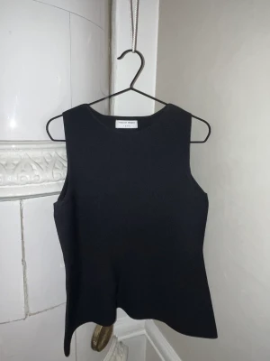 Tiger of Sweden Miliana top svart - Tiger of Sweden MILIANA top i svart. Säljer på grund av för liten. Oanvänd.  Storlek M (väldigt liten i storlek, passar S). Modellen bär strl S på bilderna.  Material: 60% viskos, 40% polyester   Nypris: 1795 kr  Länk till Zalando: https://www.zalando.se/