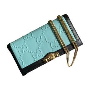 Brand new Gucci wallet on chain. Light blue GG leather with dark blue trim Double G and studs detail Viscose lining 6 credit card slots 1 zipper pocket 1 open pocket Gold tone chain strap with 58cm drop Snap closure 21 x 19 x 4cm Comes with dust bag.