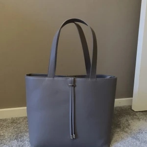 Axelväska  - En beige handväska från Anna Field med några fack i. Använd ganska många gånger. Har slitits lite på ena handtaget, som syns på 3:e bilden, men inget som syns i första hand. Köparen står för frakten. 