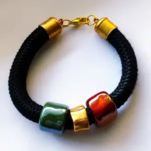 Black handmade bracelet, red and green ceramic beads, gold elements, new, 23cm length.