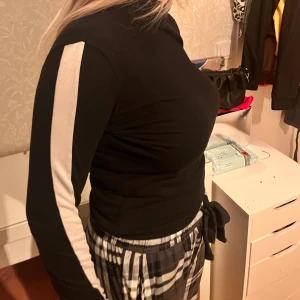 Svart tröja med vittnpå ärmarna från monki i storlek S - Använd 1-2 gånger så den är som ny, från monki i storlek S