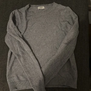 En grå stikad tröja  - Tröjan har knappt kommit till någon användning tröjan är från veromoda. 