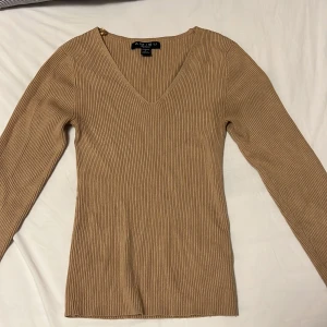 Långärmad tröja  - Mindre i storleken 