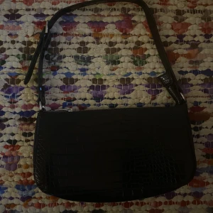 axelväska  - snygg svart axelväska i fauxläder. säljer pga brist på användning 