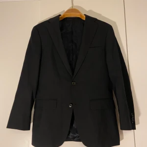 Kavaj svart  - Svart kavaj från The Glory Days. Storlek 44 på lappen men väldigt liten i storlek så skulle säga att det är som en M eller 38. Fint skick! Köpare står för frakt.