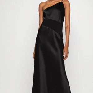 Calvin Klein Klänning 34 - Svart shine slip klänning fr Calvin Klein. Oanvänd med prislapp på! Storlek 34 Nypris: 2699kr   Fått i present men för liten.  Finns på Lilla Essingen 