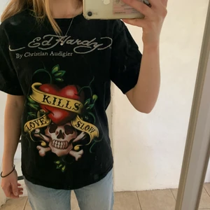Ed Hardy t-shirt - Säljer nu min skitsnygga Ed Hardy T-shirt, sparsamt använd. Det enda är att trycket spruckit litegrann på några få ställen, dock inget man tänker på.