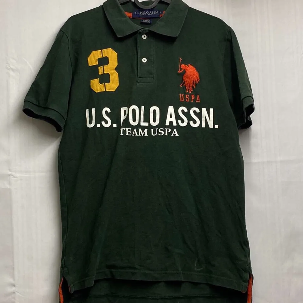 En mörkgrön Us polo tröja bra skick förut lite sprucken text, storlek S (Obs frakt ingår ej i priset). T-shirts.