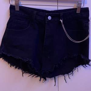 Short black shorts with a silver chain. Recently bought, never been worn/used.