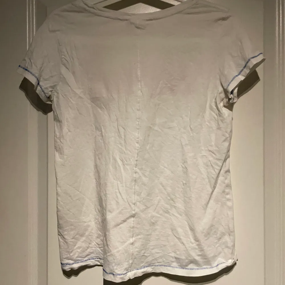 Vit T-shirt med text fram från H&M. Köparen står själv för frakten . T-shirts.
