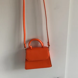 Orange väska från Gina - Liten crossbody väska köpt på Gina Tricot förra sommaren. Älskar färgen och passar så bra till sommaren och för att göra outfits mer färgglada. Köpt för 249kr. Använd mindre än 5 gånger 