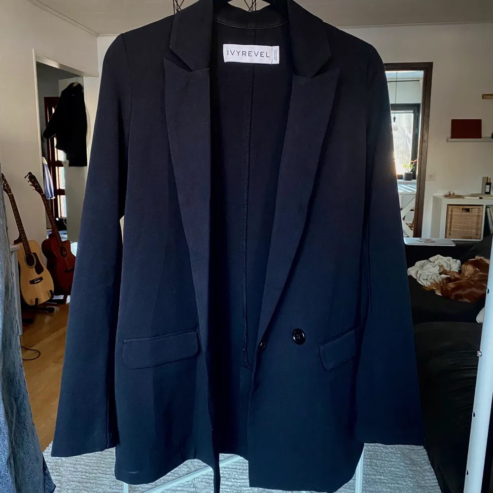 Svart fin blazer/kavaj från Ivy Revel I fint skick, inte använd mycket.  I ett mjukt tyg (inte hårt/stelt kavajtyg) Vida ärmar med slits.  Lite längre i modellen (se sista bilden) Storlek: XS/S. Kostymer.